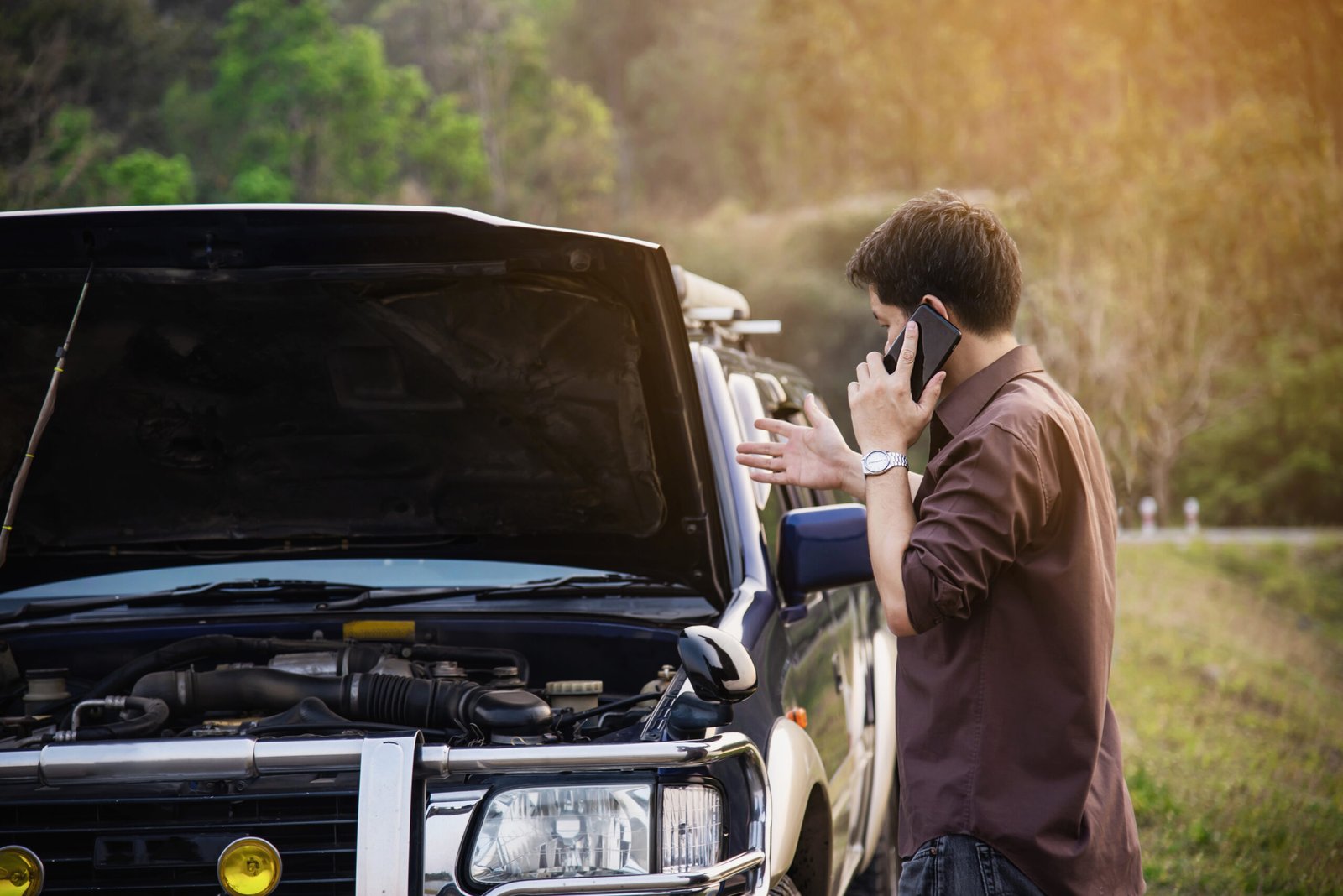 Driver beside a vehicle at the roadside after a breakdown